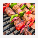 grilled steak skewers with bell peppers and onions over hot grill